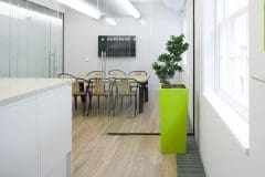 plant in tall green planter in communal kitchen and dining area