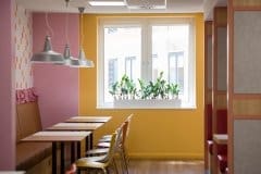 plants on window sill of cafe with orange walls