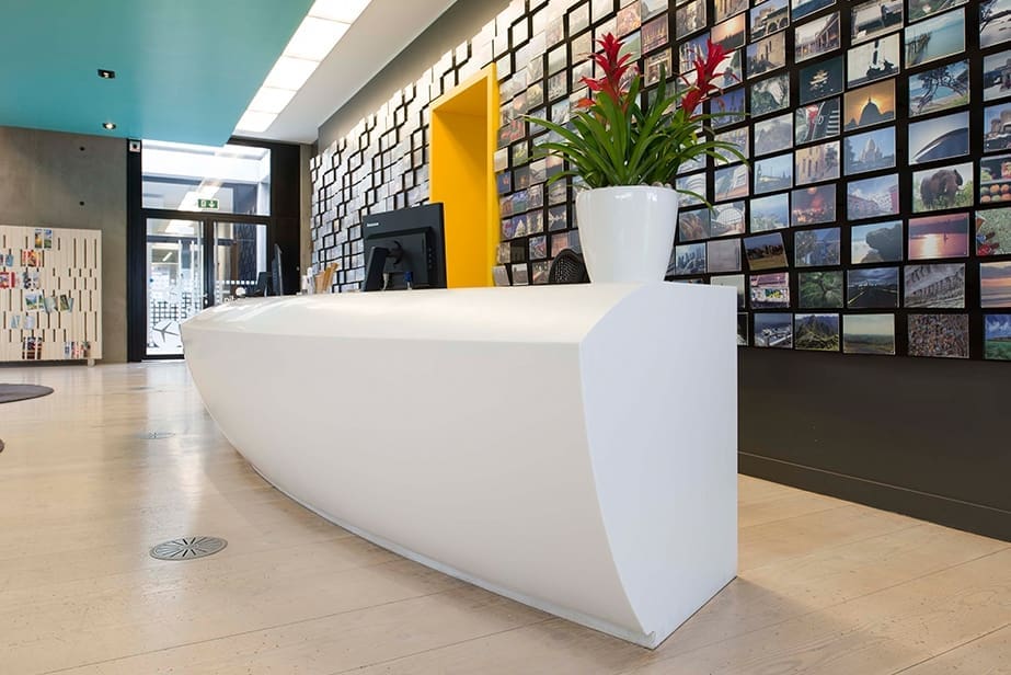 plants on white reception desk