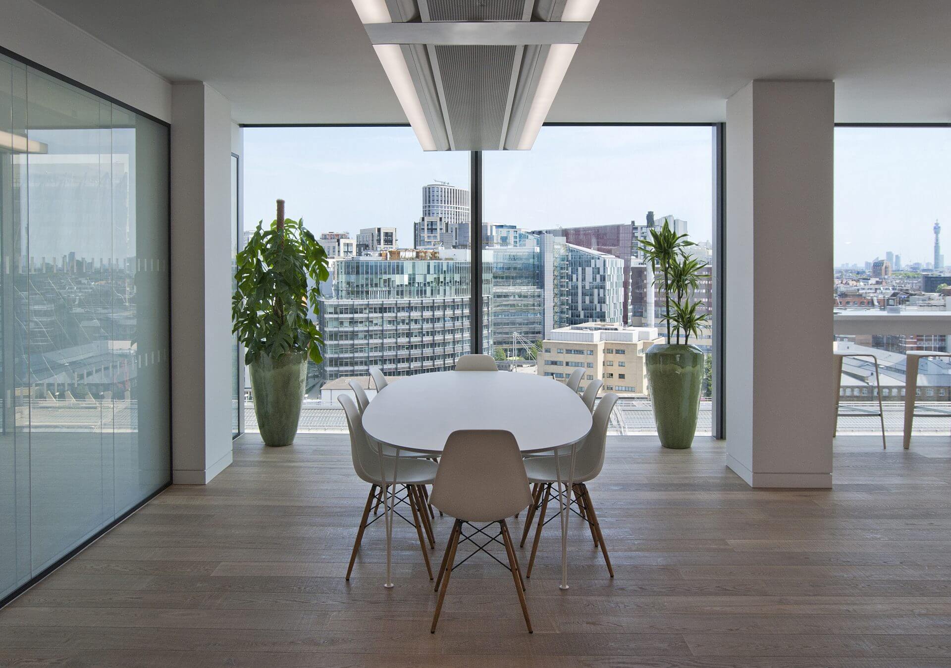 Image of the stunning biophilic design of JAB Holding Company's office, featuring natural elements such as plants, living walls, and high ceilings to create a tranquil and inviting atmosphere for employees.