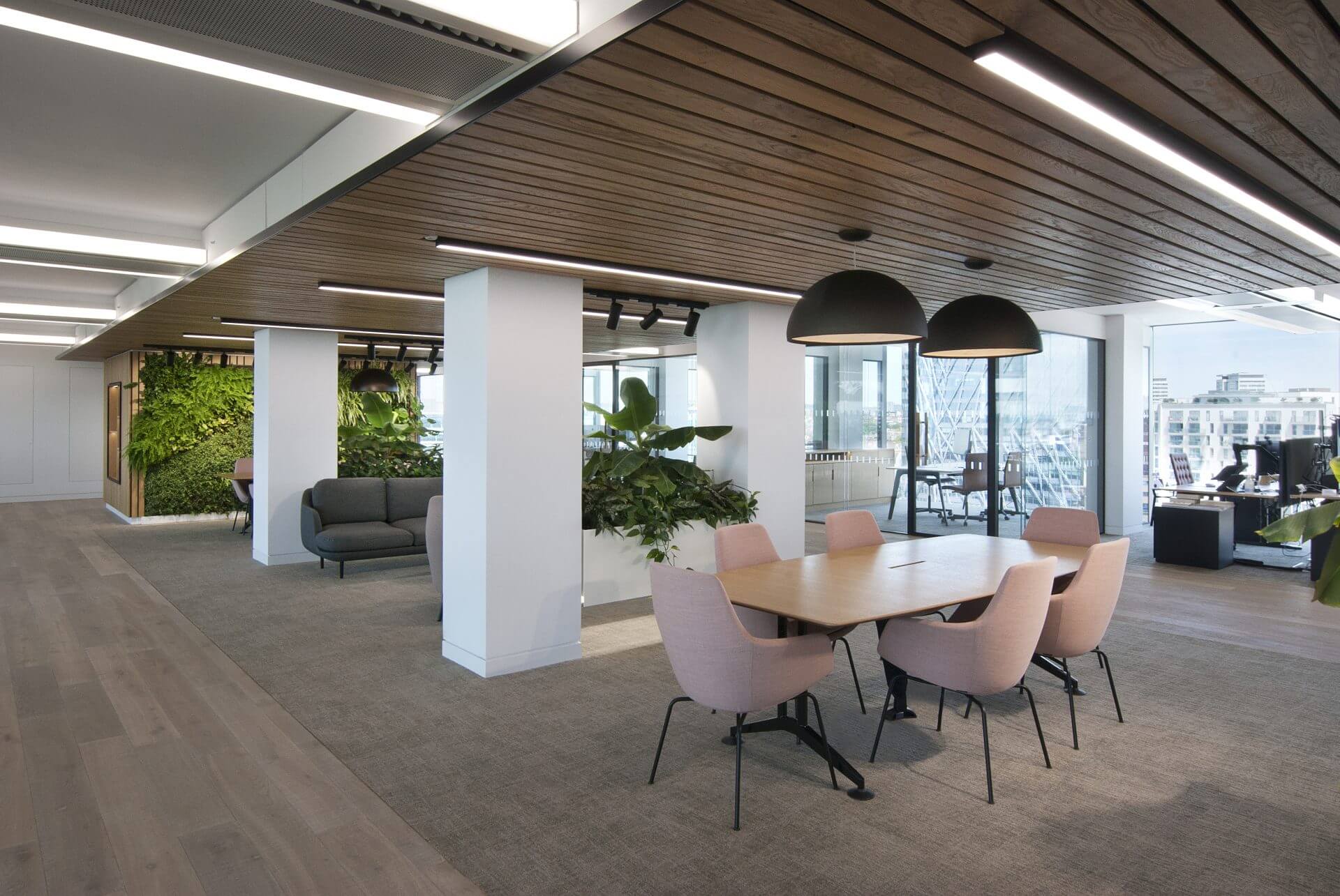 Image of the stunning biophilic design of JAB Holding Company's office, featuring natural elements such as plants, living walls, and high ceilings to create a tranquil and inviting atmosphere for employees.