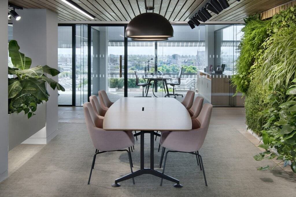 Image of the stunning biophilic design of JAB Holding Company's office, featuring natural elements such as plants, living walls, and high ceilings to create a tranquil and inviting atmosphere for employees.